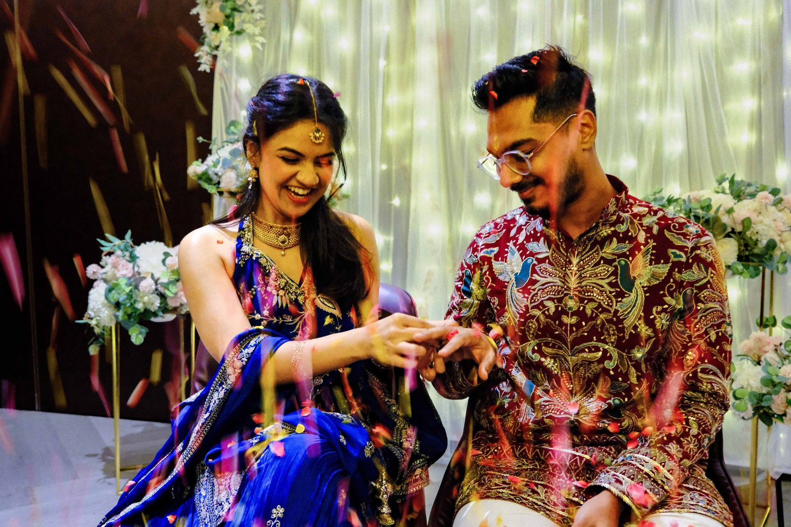 Couple laughing together as they exchange rings during the roka ceremony