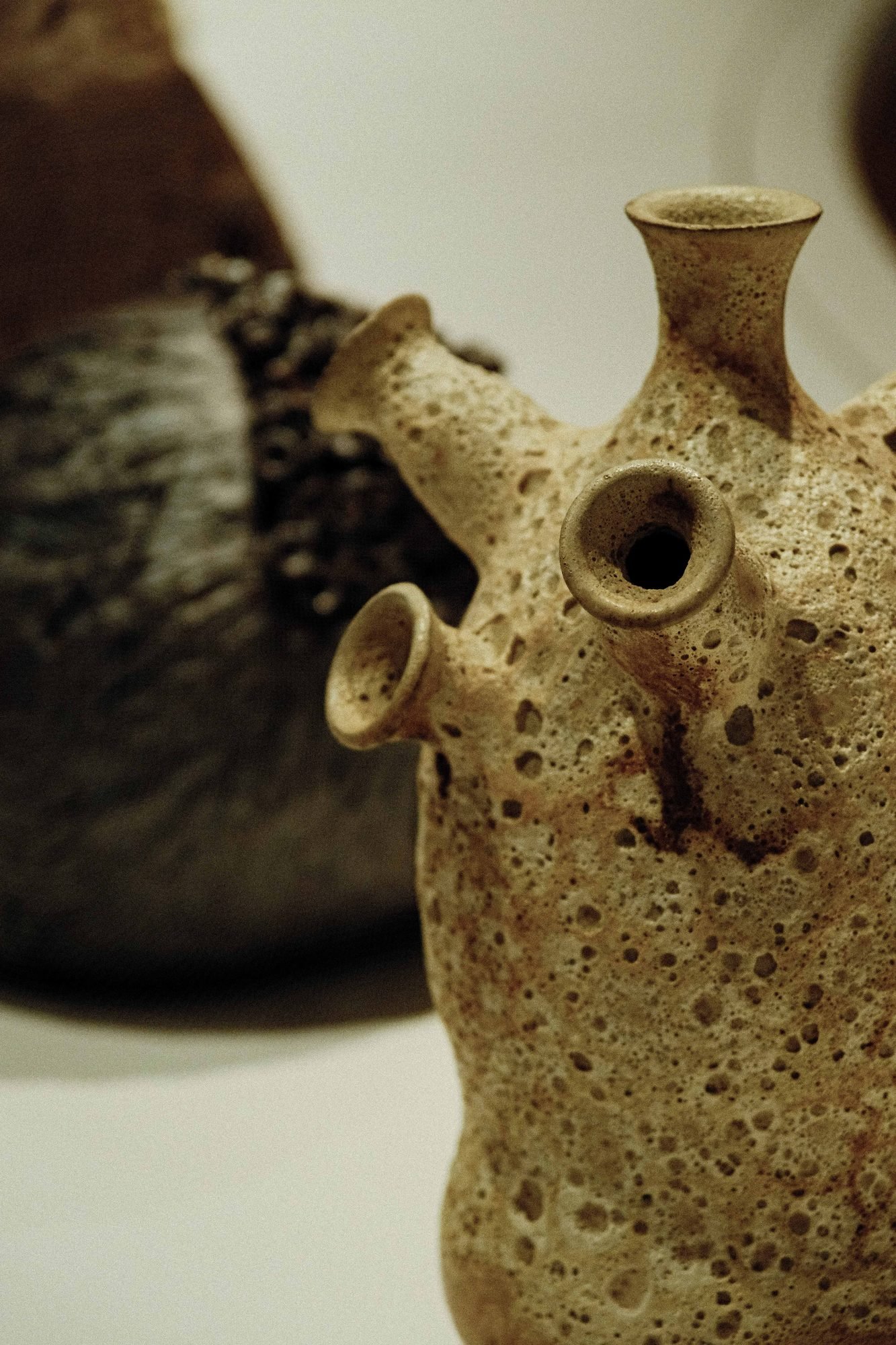 Handcrafted ceramic vessel displayed against a dark backdrop