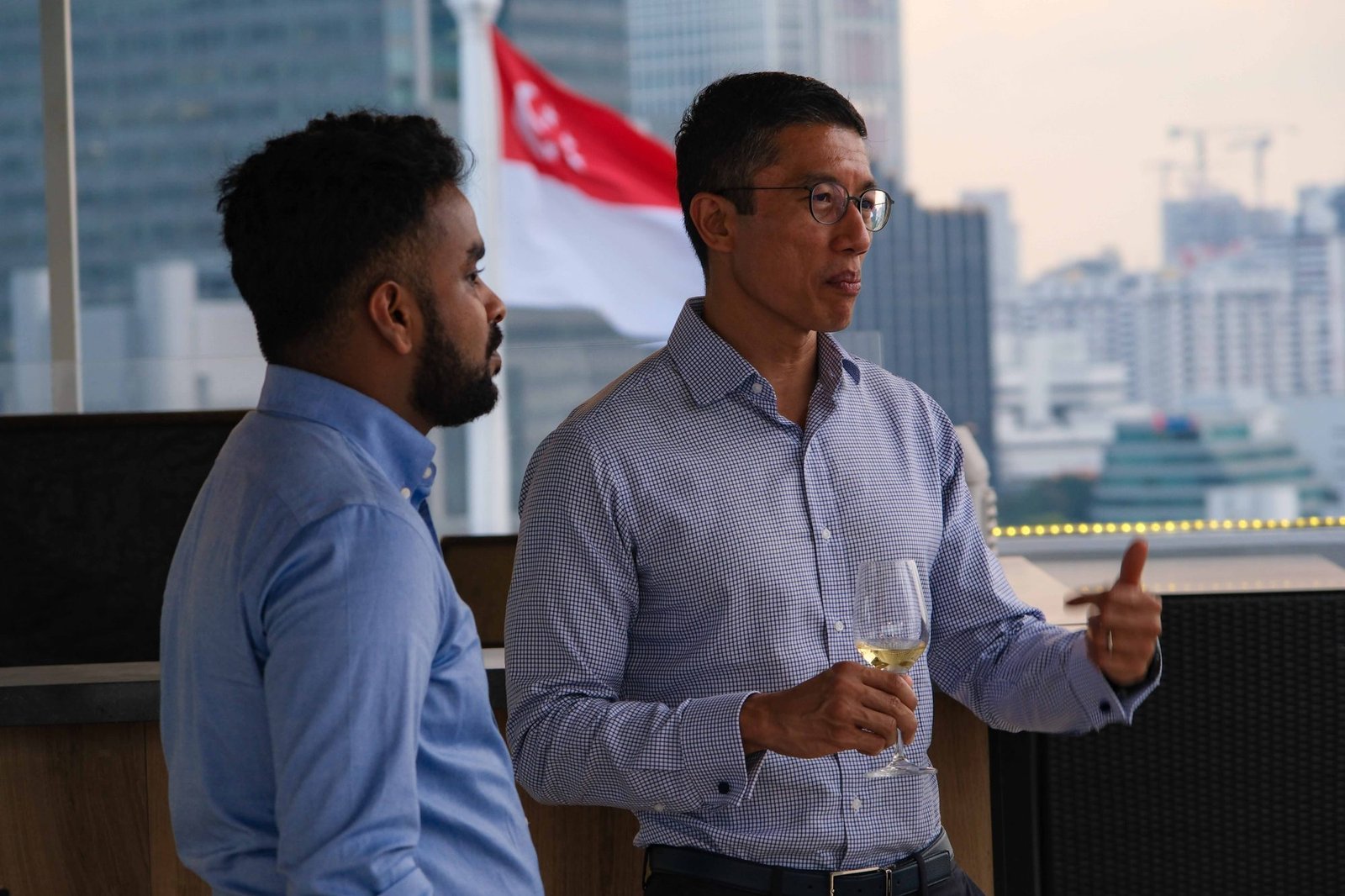 Executive gesturing while addressing colleagues on a terrace