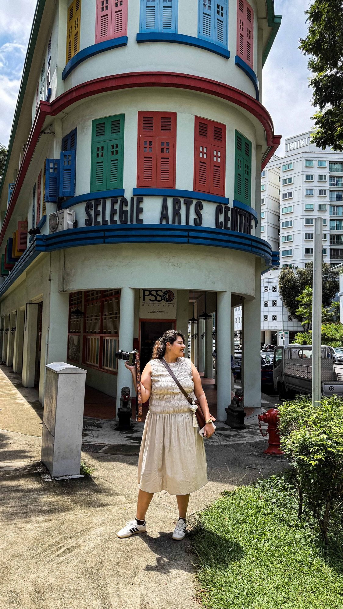 Visitor walking past a colorful heritage building exterior
