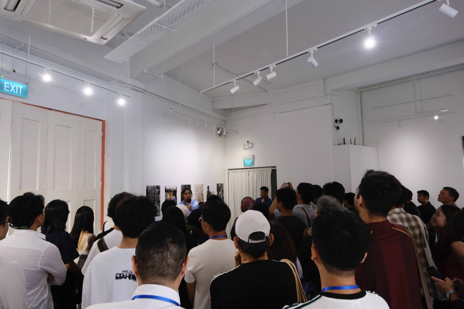 Crowd of attendees gathered inside a gallery opening