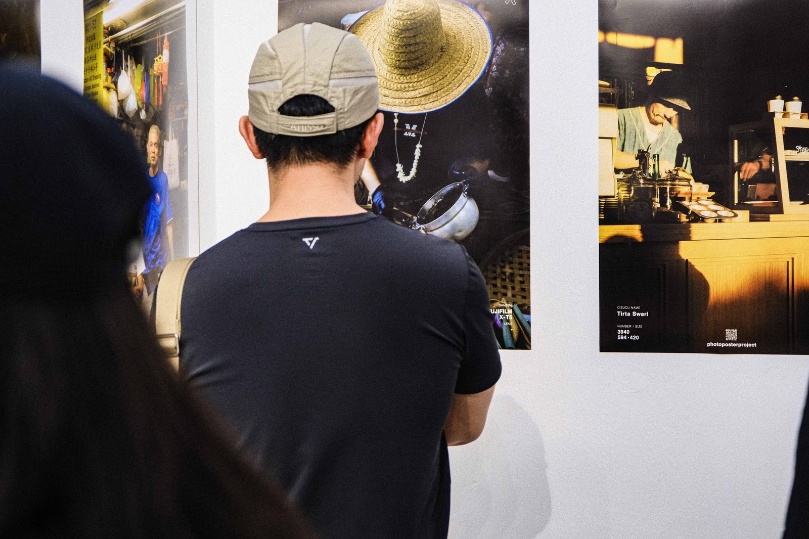 Visitor examining a framed photograph closely