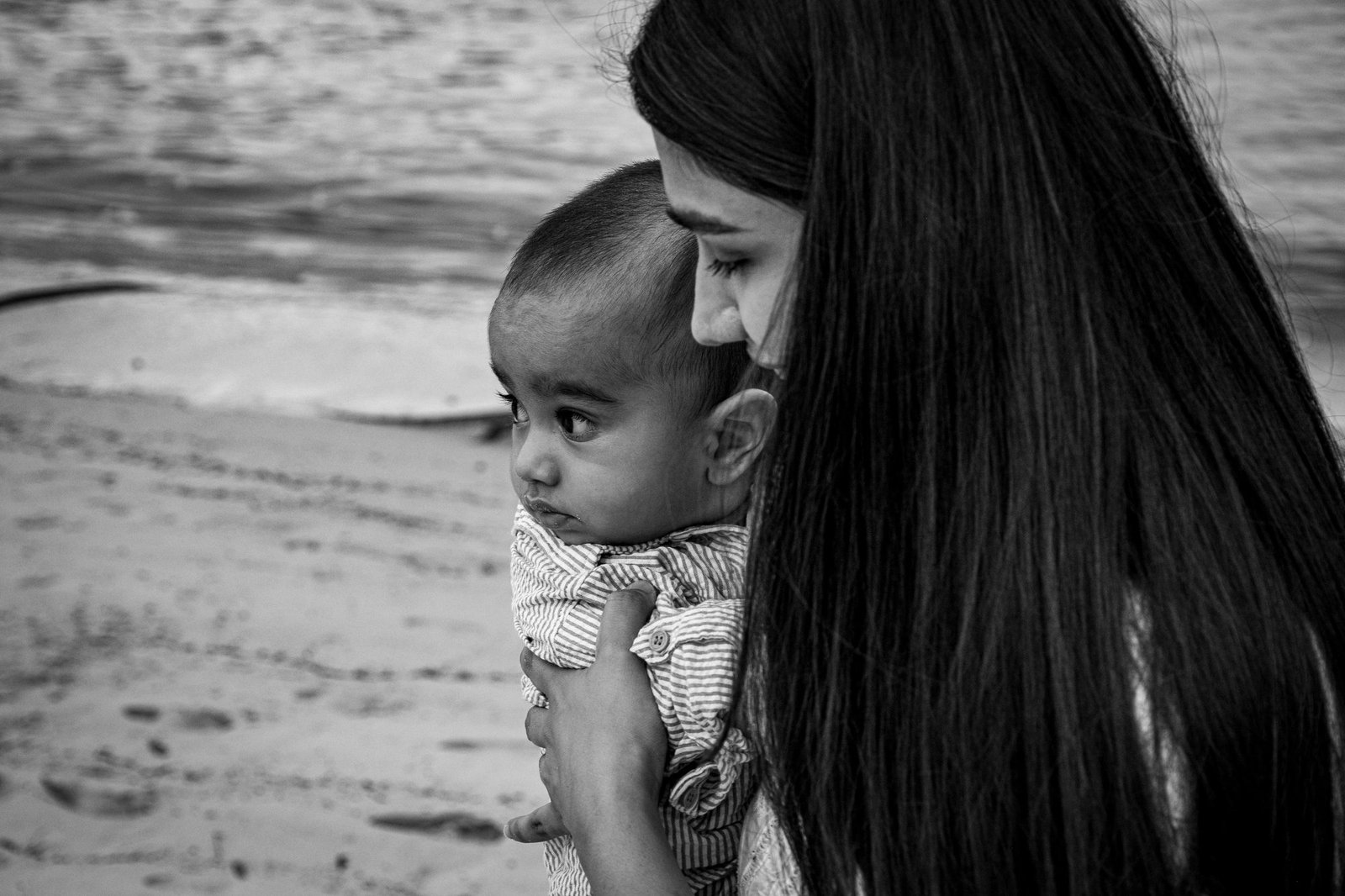 Black-and-white portrait of a mother gazing at her child