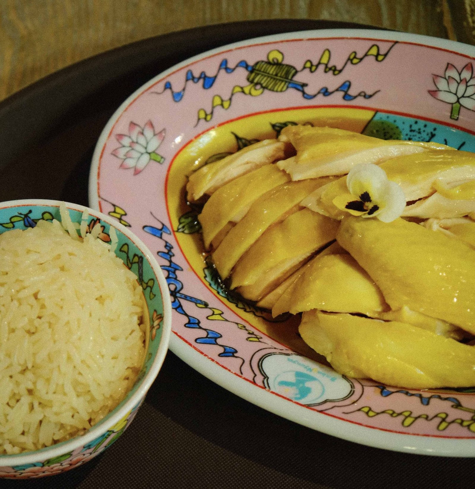 Whole steamed fish plated on a decorative dish