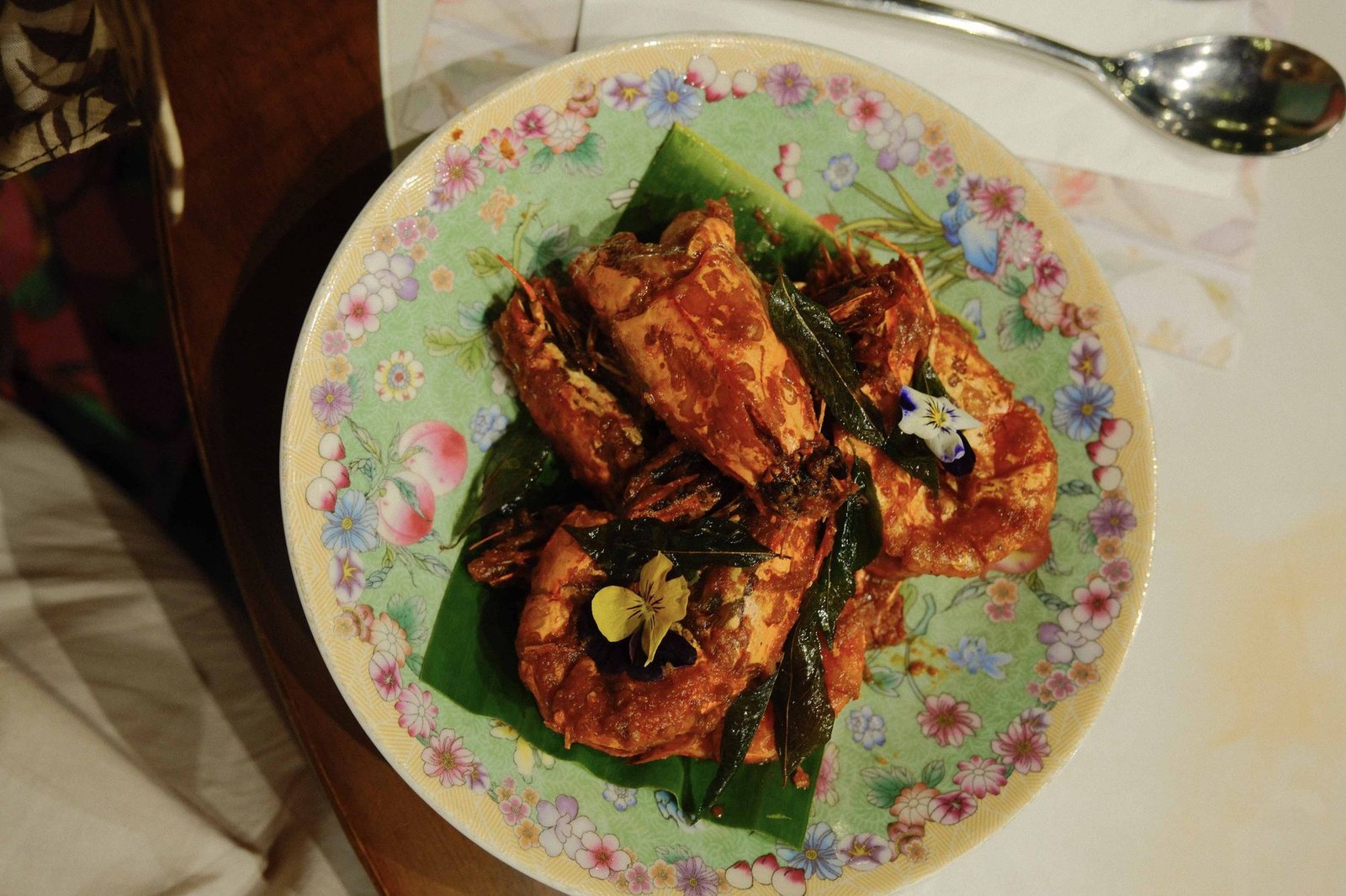 Chili crab served on a vibrant patterned plate
