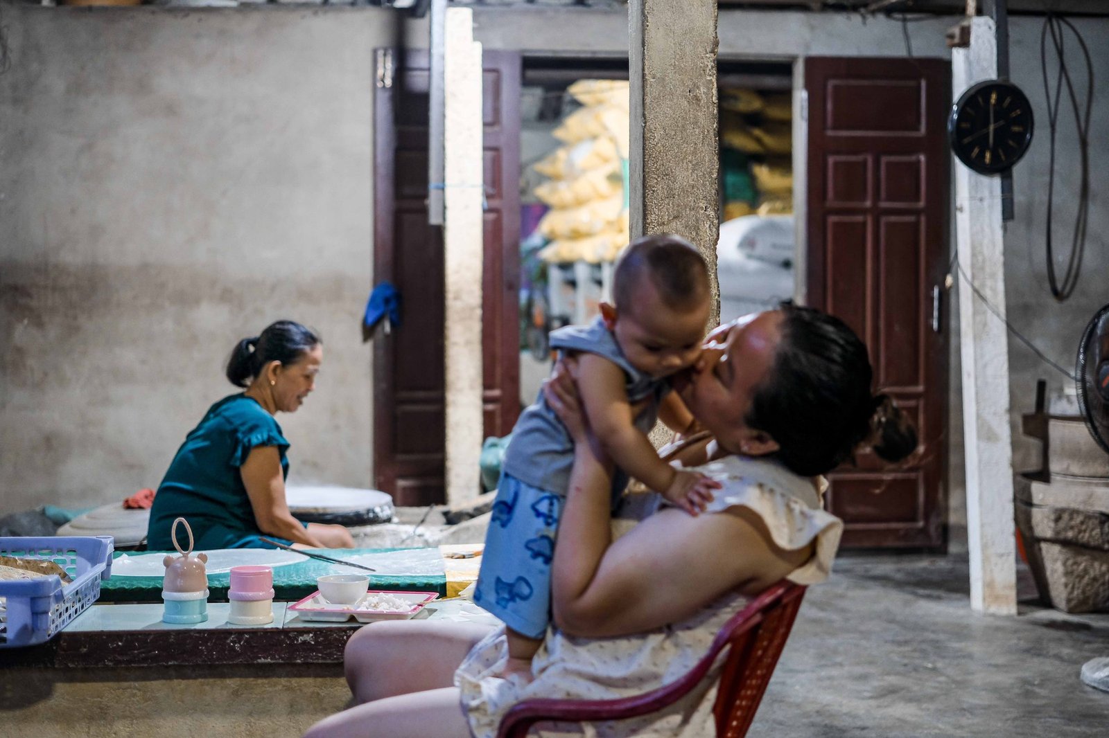 Grandmother lovingly cradling a laughing baby