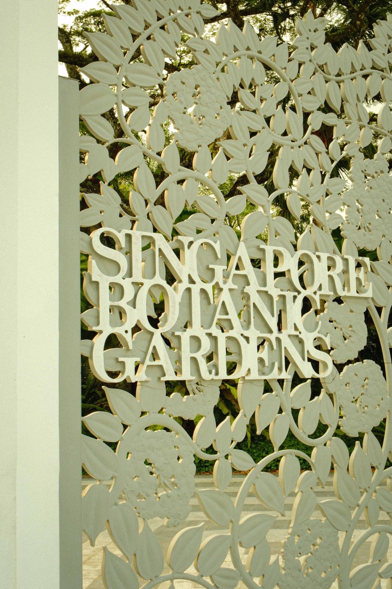 Engraved Singapore Botanic Gardens sign among foliage