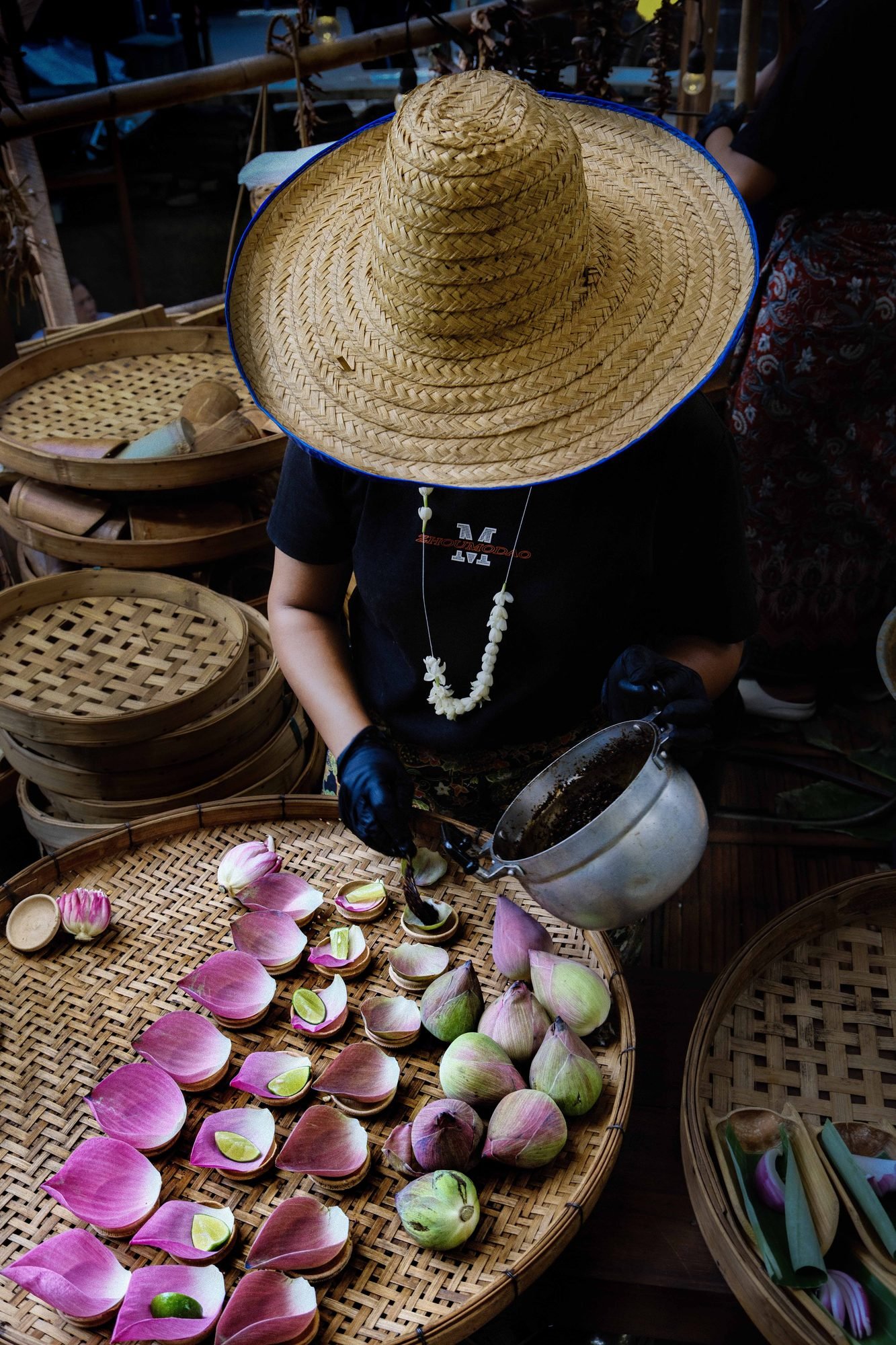 Woven straw hats displayed for sale at a Thailand market stall