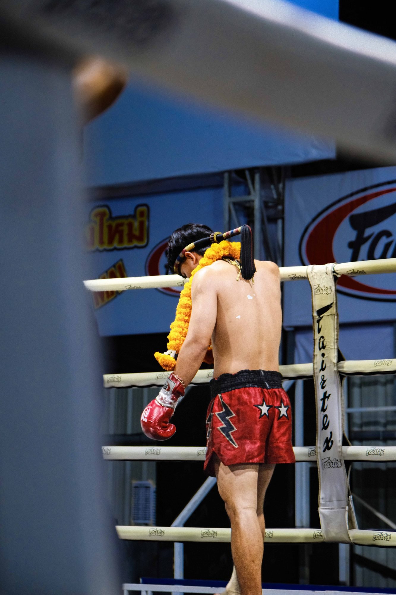 Two fighters exchanging strikes in the boxing ring
