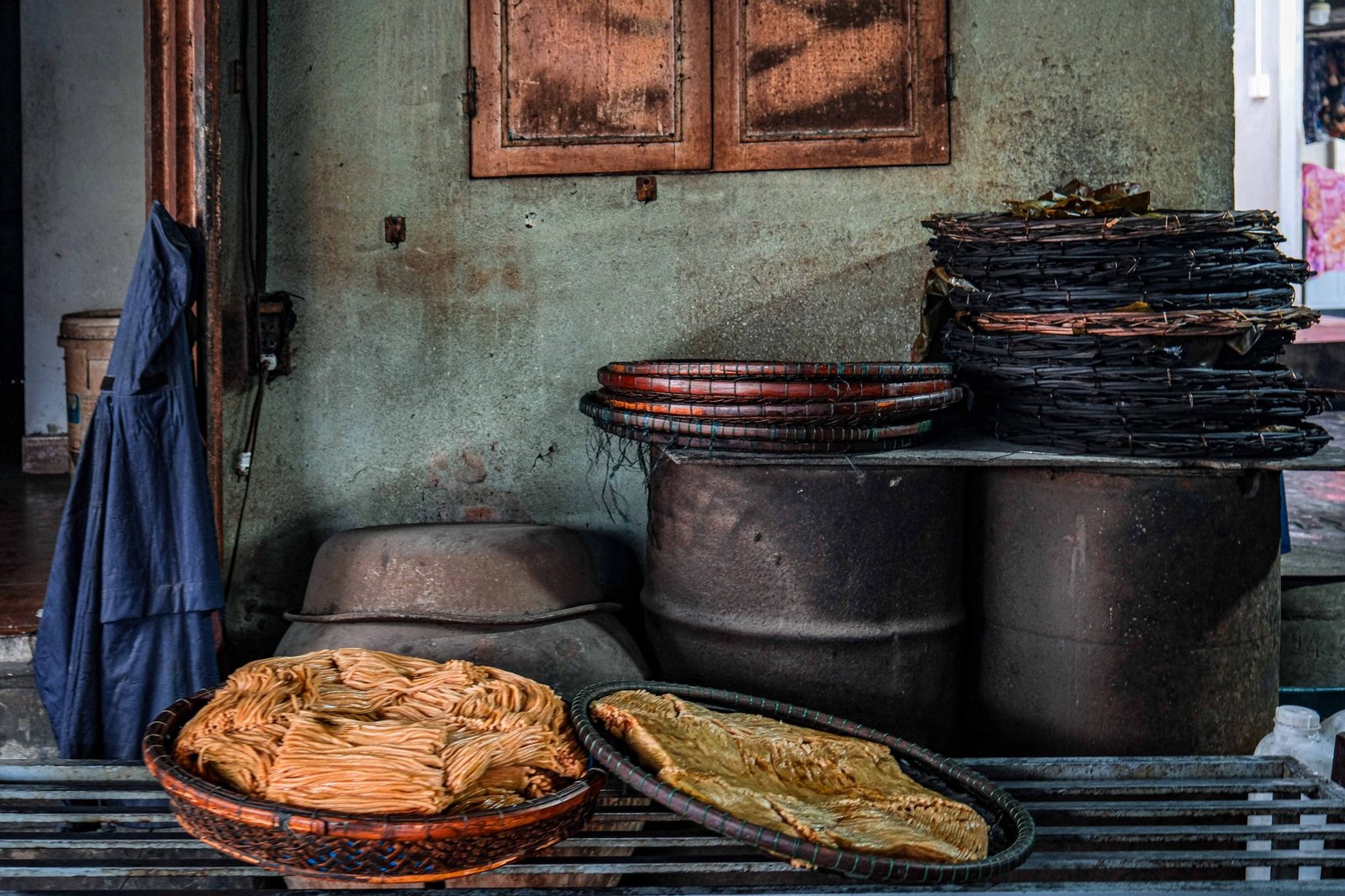 Stacked clay pots arranged outside a workshop