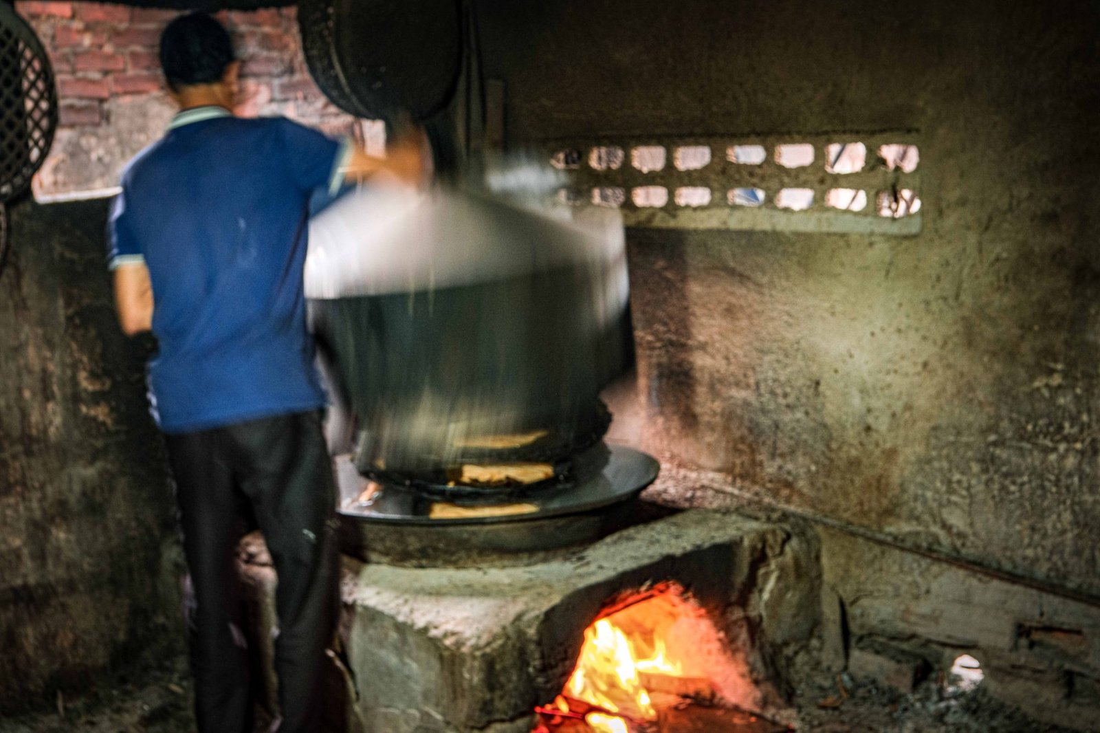 Steam rising dramatically from a traditional cooking pot